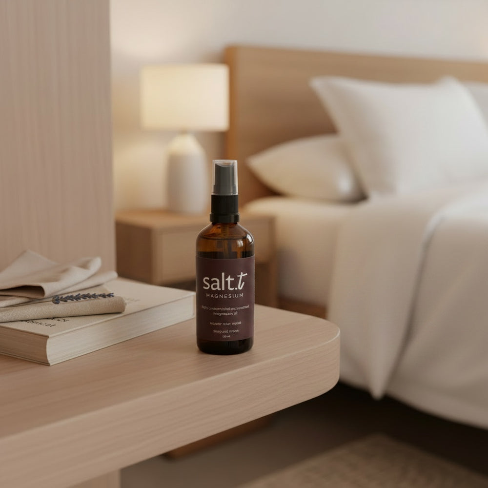 A brown glass spray bottle of Salt.T Magnesium Sleep & Anxiety Blend with a black pump and clear cap, set against a plain white background with a soft shadow