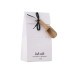 A white rectangular box with a glossy finish, featuring black graphic  wording A small black ribbon is tied around the upper right side of the box.