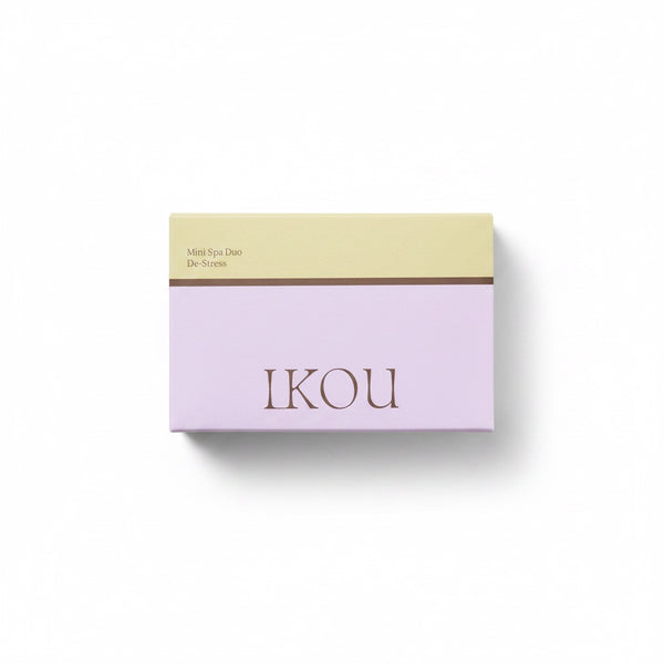 A rectangular cosmetic box for IKOU Mini Eye Diao De-Stress, featuring a two-tone design with a pale yellow top section and a lavender-purple bottom section, set against a plain white background.