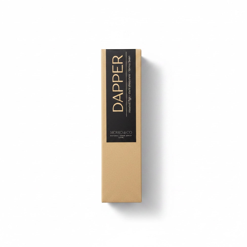 Morro & Co Dapper room spray bottle next to its kraft paper packaging box on a white background.