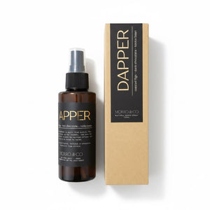 Morro & Co Dapper room spray bottle next to its kraft paper packaging box on a white background.